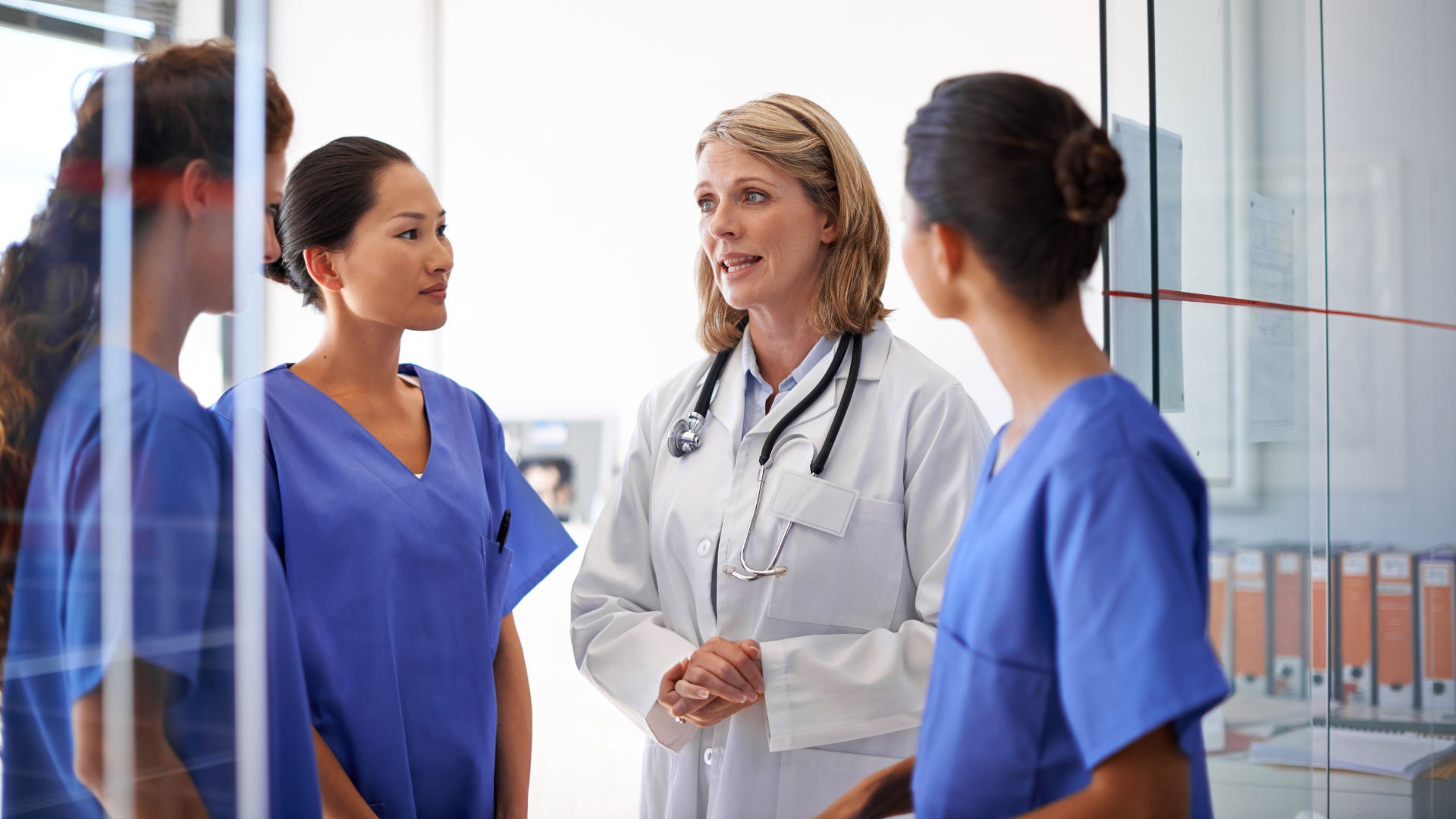 Four women physicians having a conversation