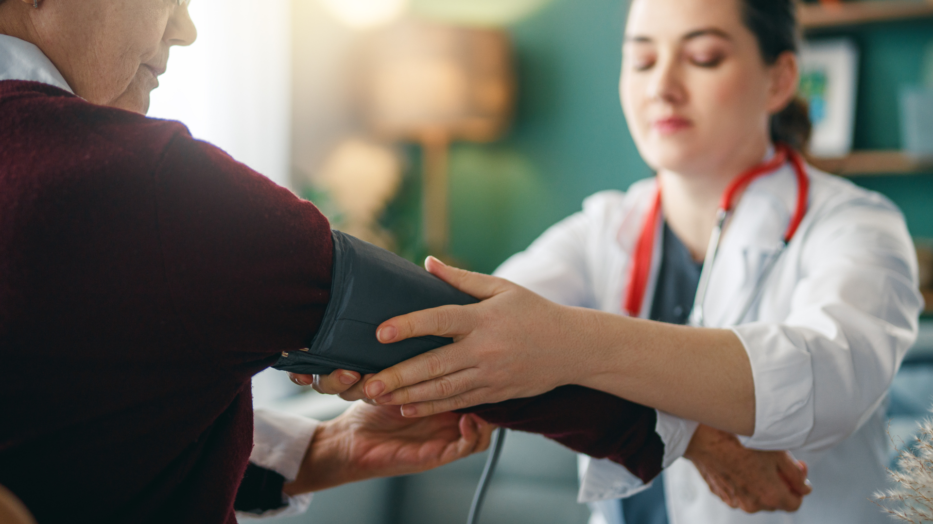 RESIL-Card tool launches. Woman doctor taking the blood pressure of a patient.