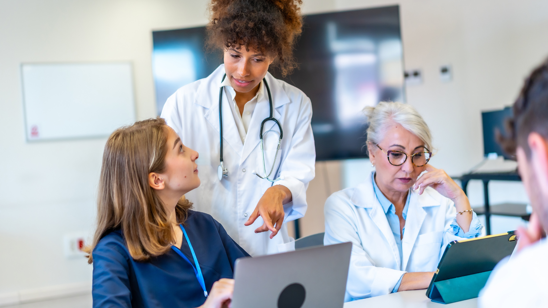 Resources 11 Three women physicians using tablets in a clinical setting