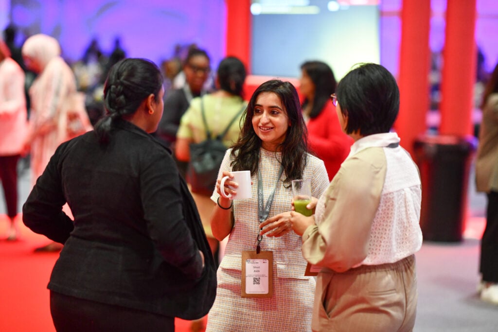 Three women physicians having a conversation during a medical conference