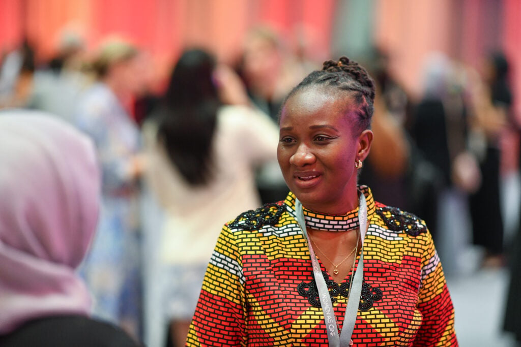 A woman physician having a conversation with another during a conference